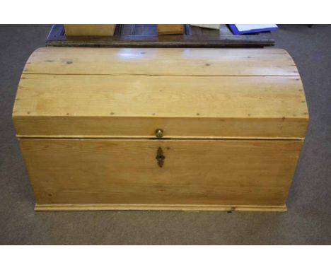 19th century pitch pine dome top trunk with void interior, retaining its original lock with cast side handles, 116cms long x 