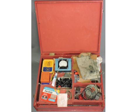 A Tri-ang Hornby boxed composite tool kit, the red box with a hinged lid and slide front containing a quantity of hobby tools