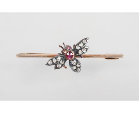 A yellow metal bar brooch having a central bee set with rose cut diamonds and finished with a ruby body &amp; eyes. Pin and h