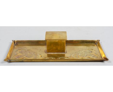 An Arts and Crafts brass inkwell, with embossed decoration, witted with a ceramic inkwell, 4.5cm high x 24cm