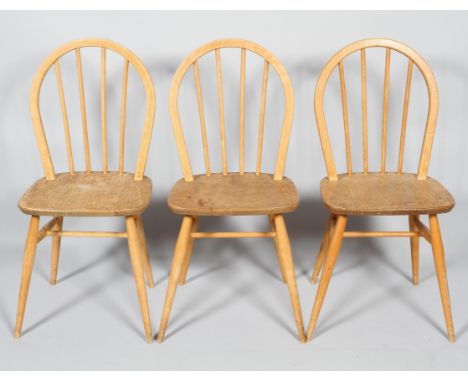 Three Ercol pale beech and elm stick back kitchen chairs, with hoop backs, on turned splayed legs, 86.5cm high