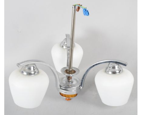 A 1960-70's chrome three-light candelabra, with white opaque shades issuing from C-shaped branches with central stem and ceil