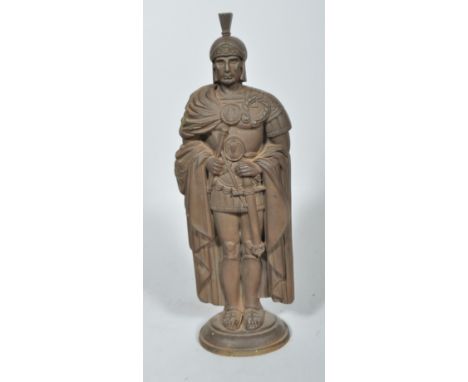 A cast iron fire companion set cast as a Roman Centurion stand, his plumed helmet forming a poker, with two hooks for further