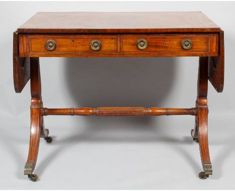 An early 19th century mahogany sofa table, the cross banded top above two drawers with later ring handles, turned supports, c