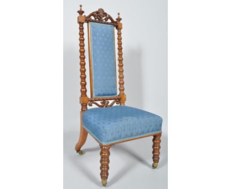 A Victorian walnut nursing chair, with high back and stuff-over seats, upholstered in blue fabric with bobbin turned uprights