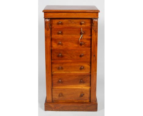 A Victorian mahogany Wellington chest, mid 19th century, with carved acanthus side panels, with seven graduated drawers and t