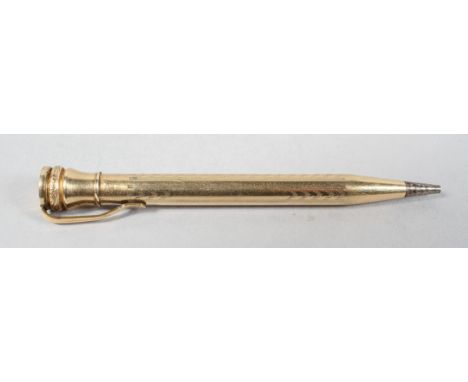 A filled gold propelling pencil, of seal end type, round form with panels of chevron engine turning, 10cm high
