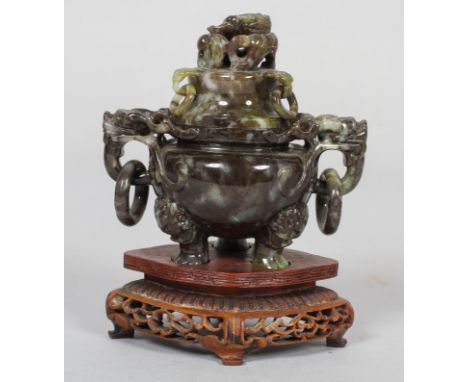 A Chinese carved mottled jade censer with cover and hardwood stand, 20th century, of mottled grey, green and brown tones, wit