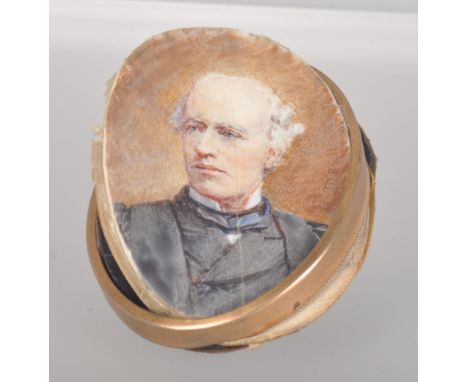 A base metal frame locket with painted portrait and suede case back. Reverse of portrait has handwritten inscription for Sir 