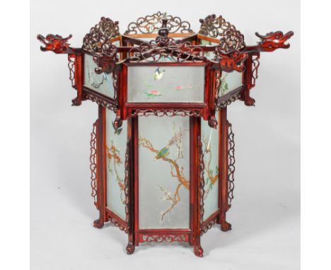 A Chinese carved wood dragon palace lantern, of hexagonal section with pierced fretwork scroll crestings, above rectangular f