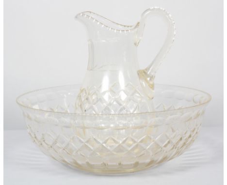 A Victorian cut glass water jug and basin, cut with diamonds, notches and lenses, within notch cut rims, the ewer 32.5cm high