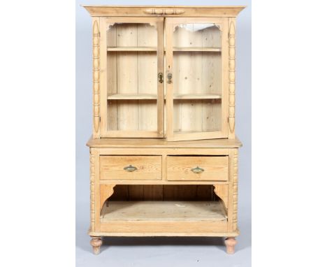 A Victorian pine kitchen dresser, the double glazed doors enclosing two adjustable shelves, carved and applied with baluster 
