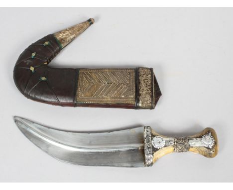 A Middle Eastern Jambiya knife with horn grip, in scabbard, with white metal mounts, 30cm long overall