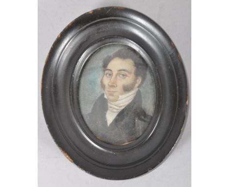 An early 19th century portrait miniature of a gentleman, watercolour on ivory, within oval recessed ebonised frame, 6.5cm hig