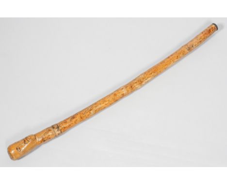 A 20th century naively carved hardwood African walking stick/cudgel, the grip modelled as a head, 80cm long