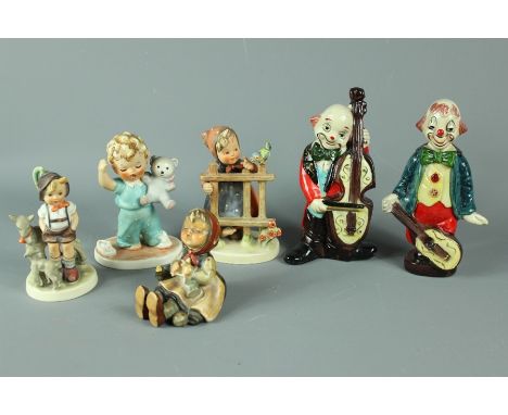 Continental ceramic figures; including two clown figures with musical instruments together with four Hummel child figures. (6