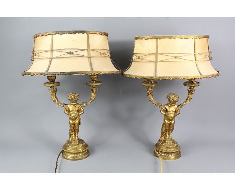 A pair of French antique gilt-bronze twin branch lamp stands, modelled as faun, approx 34 cms, complete with the original sil