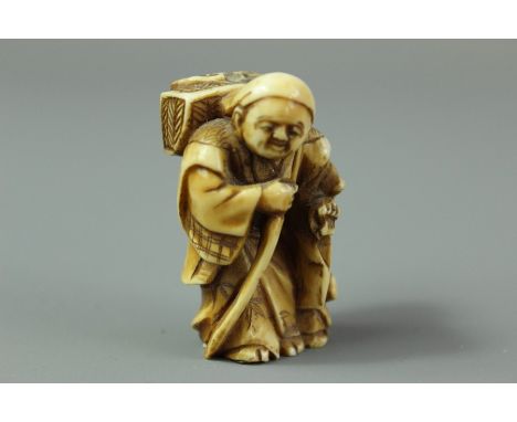 Antique Chinese ivory netsuke, depicting a fisherman with cormorant beside him.