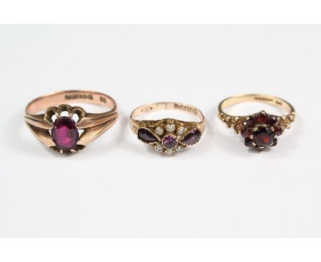 Vintage 9ct gold and garnet rings including a gentleman's 9ct gold and garnet ring, size U, a lady's 9ct gold and garnet clus