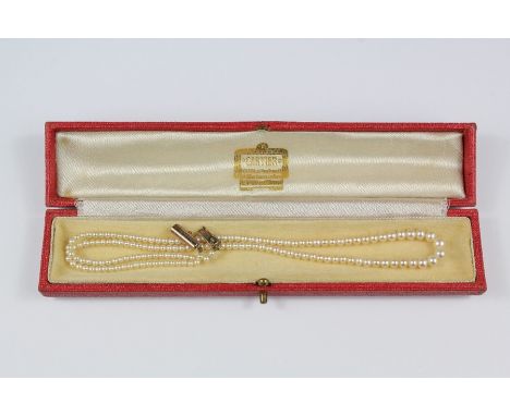 Antique single strand pearl necklace, approx 40 cms, with barrel clasp, presented in a red leather Cartier box.