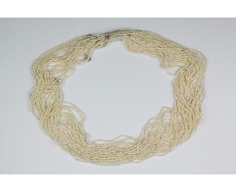 A multi-strand seed pearl necklace, approx 22 strands, approx 68 cms.&nbsp;