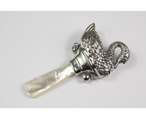 A silver infants rattle, modelled as a swan with a mother of pearl handle, approx 7 cms.
