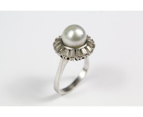 An 18ct white gold pearl and diamond ring, size Q+,&nbsp; approx 8.6 gms, the ring set with a pearl approx 10.3 mm, surrounde