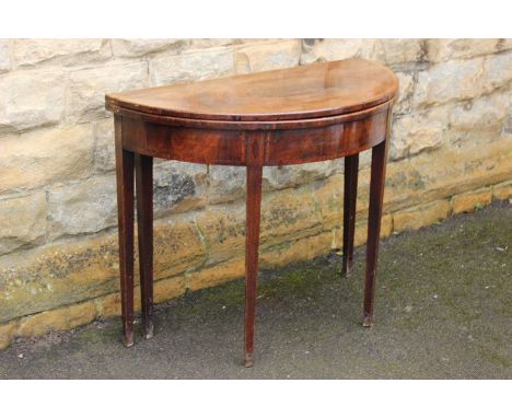 A mahogany demi-lune table, light banding to outer edge of top and legs, approx 90 w x 74 h cms.