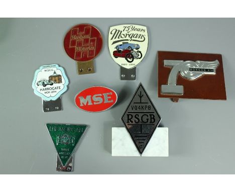 A selection of seven car mascots; the mascots include "The&nbsp; Morgan Three Wheeler Club", a RSGB VQ4KPB on a marble plinth