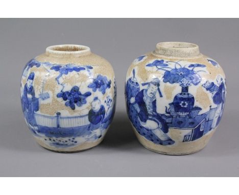 A pair of early 20th century circa 1900, crackle glaze ginger jars, overglazed with painted blue figures in a patio setting, 