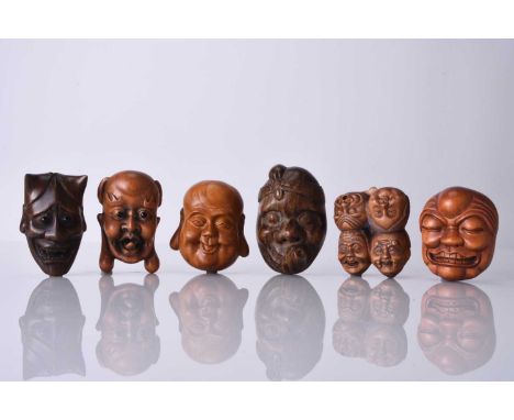 A group of six Japanese wood netsuke of masks, 20th centuryIncluding five demons and one laughing Buddha, signed.Largest 5.5c