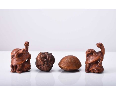 A group of four Japanese wood netsuke of turtles, 20th centuryNaturalistically modelled, three inset with horn eyes, signed.L