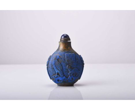 A Chinese carved lapis lazuli snuff bottle, Qianlong seal mark but 19th centuryOf ovoid form and carved in low relief with a 