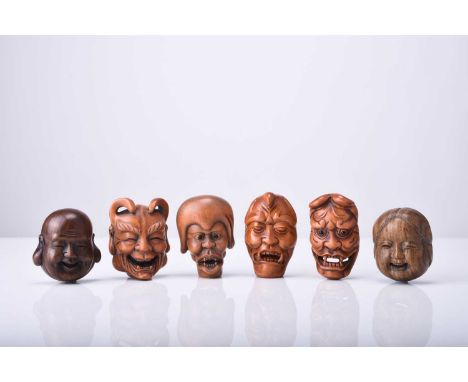 A group of six Japanese wood netsuke of masks, 20th centuryFour of oni and two of laughing Buddhas, signed.5cm (6)Provenance: