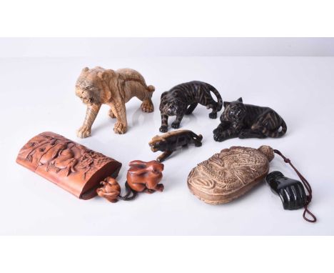 An assembled group of Japanese okimono including: a carved banded stone figure of a tiger; a carved tiger's eye figure of a t