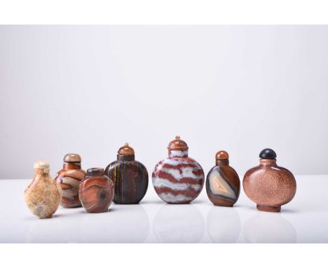 A group of seven Chinese hardstone snuff bottles, 19th/20th centuryAll of flattened ovoid form and including agate, moonstone