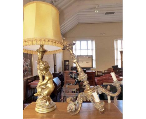 Gilt six branch centre light and large cherub tale lamp complete with shade. A condition report is not available for this lot