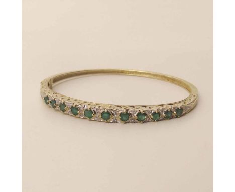9ct gold emeral and diamond bangle. A condition report is not available for this lot.  Damage, defects, restoration or other 