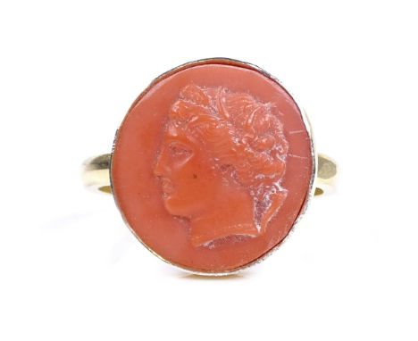 A silver-gilt relief carved coral panel ring, depicting Classical portrait, setting height 15.1mm, size M, 2.8g 