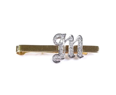 An unmarked gold diamond set initial M tie clip, unmarked settings test as 18ct gold, clip length 42.9mm, 5.1g 