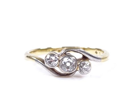 An 18ct gold 3-stone diamond crossover ring, central stone approx 0.1ct, total diamond content approx 0.2ct, setting height 6