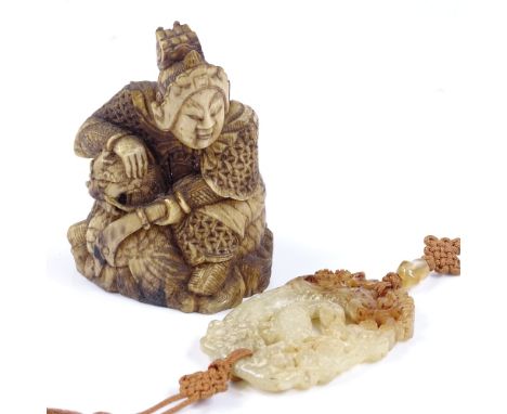 A Chinese 18th century carved ivory okimono, depicting a warrior fighting a dragon, height 7.5cm, and a Chinese carved and pi