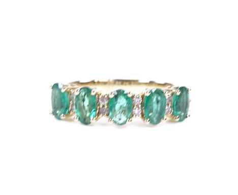 A 14ct gold emerald and diamond half-hoop ring, total oval-cut emerald weight approx 1.11ct, total diamond content approx 0.1