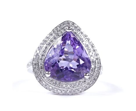 A 14ct white gold amethyst and diamond cluster dress ring, with diamond set shoulders and pierced bridge, pear-cut amethyst a