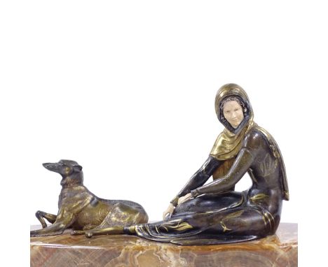 An Art Deco style gilded and patinated spelter figure of a woman with a Borzoi dog, on onyx plinth base, length 60cm 