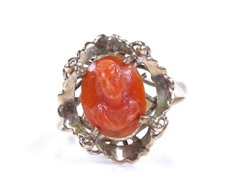 An unmarked gold relief carved coral panel ring, depicting portrait bust, setting height 16.6mm, size M, 2.3g 