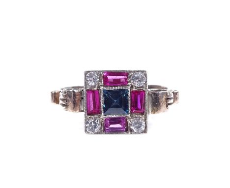 An Art Deco unmarked gold sapphire ruby and white sapphire panel ring, with scrolled shoulders, setting height 9.4mm, size L,