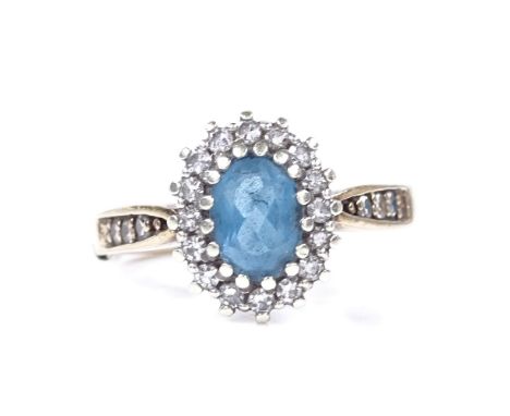 A 9ct gold blue topaz and diamond cluster ring, with diamond set shoulders, setting height 11.9mm, size M, 3.3g 