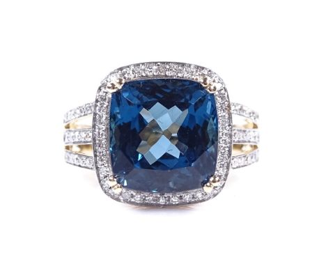 A 14ct gold blue topaz and diamond cluster ring, with diamond set shoulders, cushion-cut topaz approx 7.3ct, total diamond co