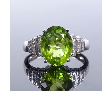 A 14ct white gold solitaire peridot ring, with stepped diamond set shoulders, oval-cut peridot approx 3.56ct, total diamond c